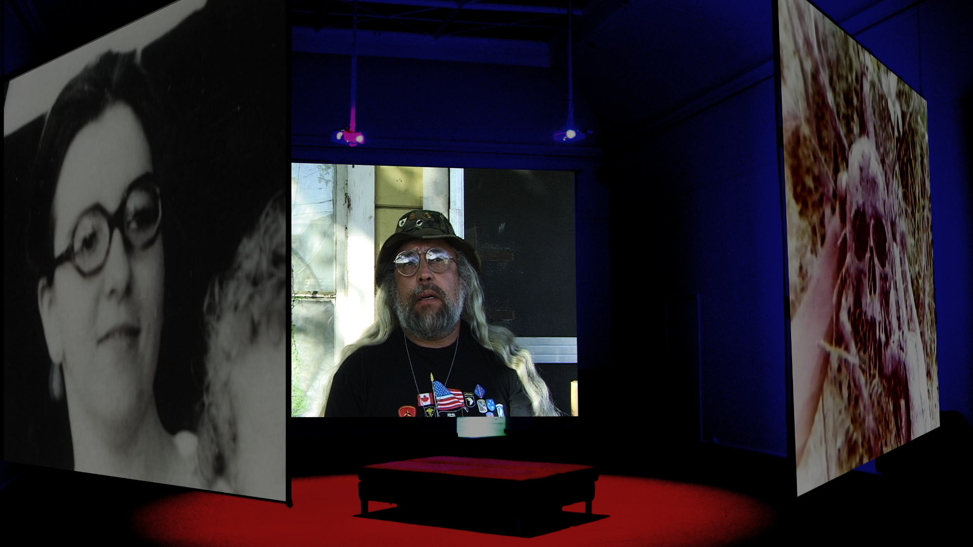 The Two Faces of Roman Martinez installation view. The film and the installation revolves around the experiences of three generations of American combat veterans suffering from PTSD that meets for therapy sessions. The main character is Roman Martinez, a Vietnam veteran